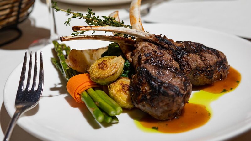 Lamb chop entree with side of brussels sprouts and asparagus